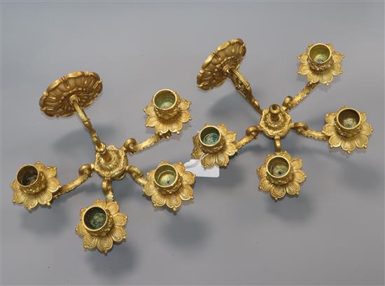 A pair of gilt metal four branch wall lights